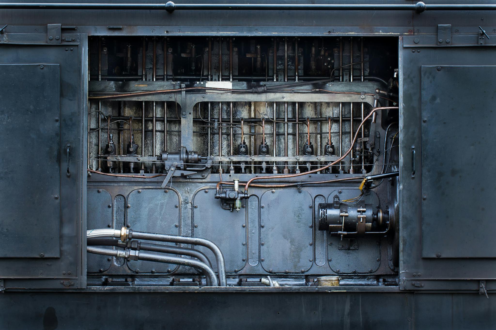 Detailed view of complex industrial machinery parts and metal pipes.